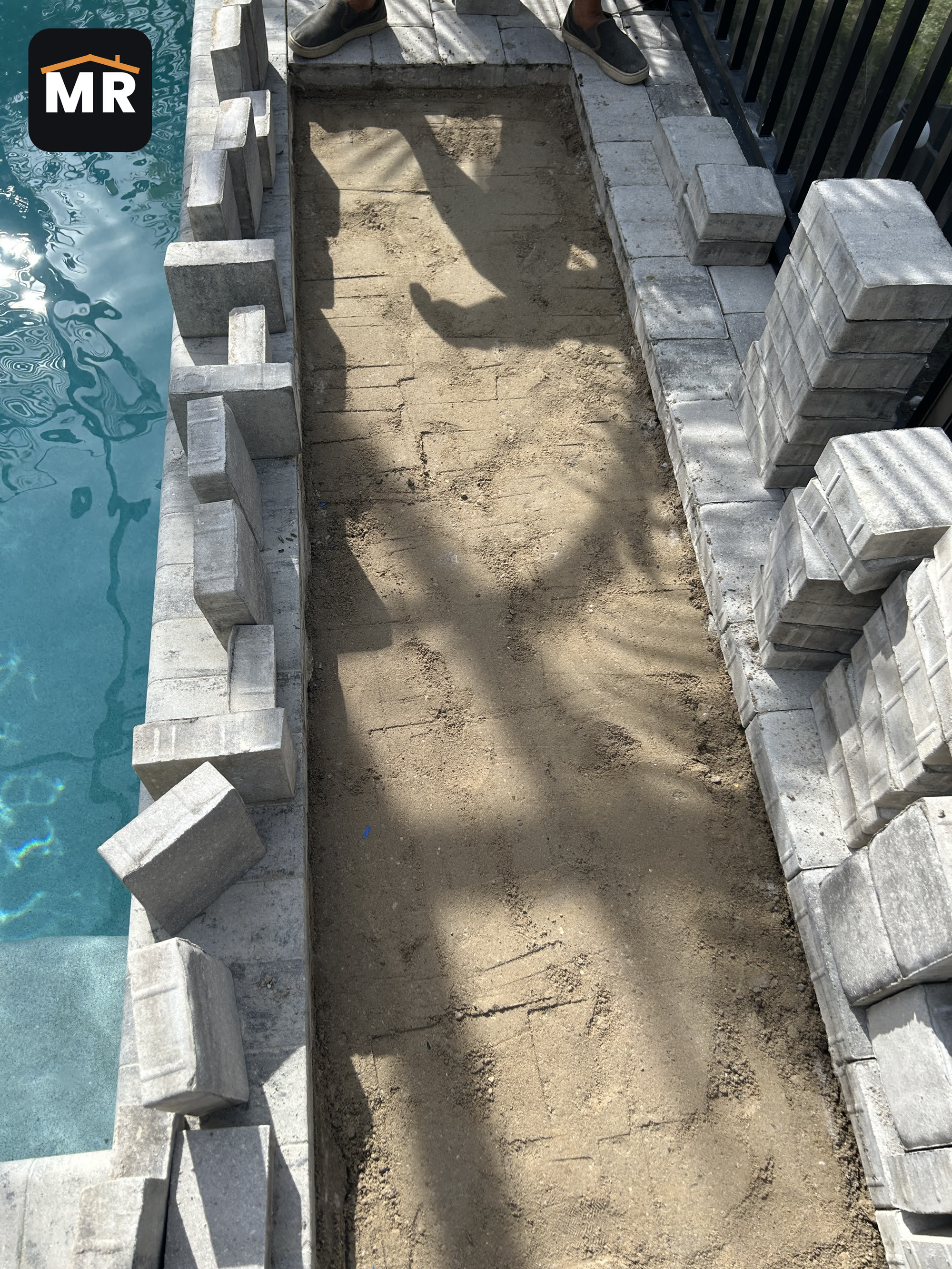 Sunken pavers lifted along a Nokomis pool deck edge with the old base exposed